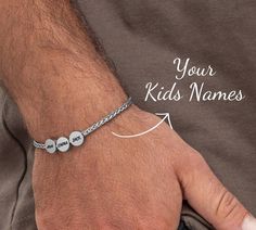 Get your man something personal and stylish for a special occasion.  Introducing our beautifully crafted Dad Bracelet With Kids Names, a sentimental piece that celebrates the loving bond between a father and his children. This personalized bracelet is carefully handcrafted with precision and love, featuring delicate circle pendants that can be customized with the names of his beloved little ones. Each circle represents a precious child, making it a heartfelt keepsake that he will cherish forever Engraved Round Braided Bracelets As Gift, Engraved Braided Bracelet As Gift, Engraved Braided Bracelets As Gift, Engraved Braided Bracelet Gift, Personalized Adjustable Chain Bracelet For Father's Day, Father's Day Personalized Adjustable Chain Bracelet, Adjustable Chain Bracelet For Father's Day Gift, Adjustable Chain Bracelet For Father's Day, Personalized Bracelets For Birthday Gift On Father's Day