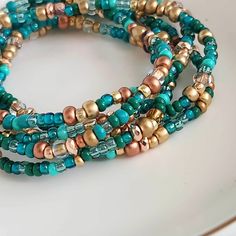 Gorgeous, handcrafted wrap bracelet is made with a mix of deep shades of jade green and gold seed beads, crystals, and faceted beads.  This 41-inch-long bracelet can wrap 5 to 6 times on wrist sizes from 6 to 8 inches.  Perfect for any occasion, casual or dressy, it also makes a nice gift.   Please message me for any special size requests. Gold Bohemian Wrap Bracelet With Spacer Beads, Multi-strand Faceted Beads Wrap Bracelet For Jewelry Making, Gold Hand-wrapped Beaded Bracelets, Gold Bohemian Wrap Bracelet With Faceted Beads, Bohemian Gold Beaded Crystal Bracelet, Bohemian Wrap Bracelet With Faceted Round Beads, Spiritual Wrap Bracelet With Faceted Beads, Spiritual Rondelle Beaded Bracelet With Spacer Beads, Green Bohemian Stretch Bracelet With Faceted Beads