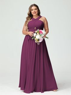 a woman in a long purple bridesmaid dress with flowers on the waist and shoulders