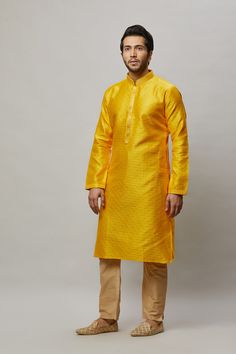 Brocade self embossed kurta with minimal gold embroidery on the placket and contrasting churidar Crafted with a collar neckline, full sleeves, and front hook closure. Occasion: Can be worn to lighter events like Mehendi, Puja, or a small party WASH CARE INSTRUCTIONS - Please Dry clean only when it is applicable. Slight color variation is possible due to digital photography. Long Sleeve Sherwani With Zari Weaving, Fitted Long Sleeve Churidar For Puja, Transitional Long Sleeve Sherwani With Zari Weaving, Festive Kurta With Dabka And Stand Collar, Long Sleeve Nehru Jacket With Dabka For Puja, Long Sleeve Bollywood Salwar Kameez For Puja, Long Sleeve Nehru Jacket For Festive Puja, Long Sleeve Sherwani With Zari Weaving For Diwali, Formal Long Sleeve Kurta For Navratri