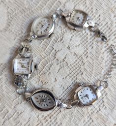 Bling! I wanted some sparkle today and I was so excited to make this bracelet! This one is made from vintage watches dating from the 1930s and up. There are a variety of watches used; this one includes two Caravelle,  Benrus 10k RGP, Lonjen with baguette crystals (center), Waltham 17 jewel 10k RGP. All of the watches have pearly white faces with silver hands and numerals. STUNNING!  The watches are non-functioning but each is a little piece of beautiful art! Given the age of the components, there will be scratches and scuffs on the watches and crystals. Some may be missing hands or the winding mechanism, but I think that just adds to the vintage look! The clean lines give it a deco look. These bracelets make a statement and are perfect for anyone who loves vintage or steampunk style. Wear Vintage Silver Metal Jewelry And Watches, Antique Silver Jewelry And Watches For Wedding, Vintage Formal Jewelry With Bracelet Strap, Timeless Metal Bracelets For Wedding, Vintage Bracelets With Clasp As Gift, Vintage Silver Jewelry And Watches For Gifts, Formal Metal Bracelet With Vintage Charm, Vintage Jewelry For Anniversary With Bracelet Strap, Handmade Silver Jewelry For Vintage Events