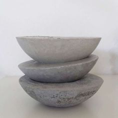 three stone bowls stacked on top of each other