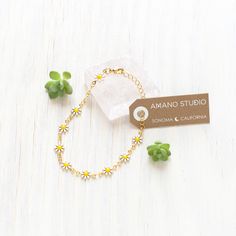 This delightful Daisy Chain Bracelet is the perfect accessory to brighten up any outfit. Its 7" length provides a comfortable fit, and the 14k gold plated brass and enamel materials give it a luxurious look. Add a touch of charm and happiness to your day with this cheerful bracelet. 7" length. Made of 14k gold plated brass + enamel. Daisy Chain Bracelet, 60's Mod, Native American Heritage Month, Bead Collection, Sonoma California, Production Studio, Small Workshop, History For Kids, Reading Gifts