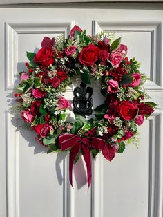 a wreath on the front door decorated with flowers