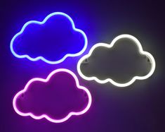 three neon clouds sitting on top of a table