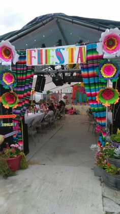 an outdoor festival with colorful paper flowers and decorations