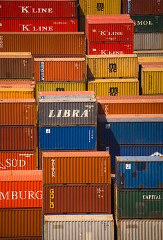 many different colored shipping containers stacked on top of each other