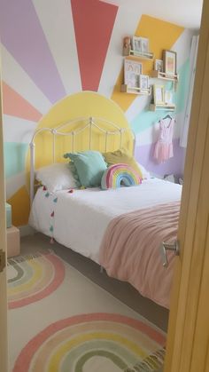 a bedroom decorated in pastel colors with a white bed