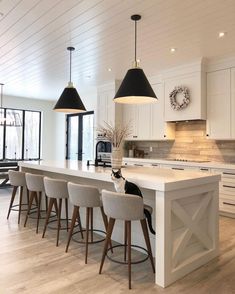 an instagram photo of a kitchen island with bar stools