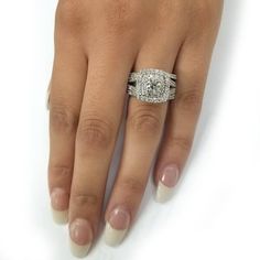 a woman's hand with a diamond ring on it