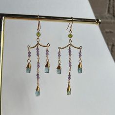 Stunning contemporary dangle earrings made with blue kyanite and amethyst. Earring posts are gold plated and hypoallergenic. Gold Amethyst Dangle Chandelier Earrings, Blue Amethyst Dangle Earrings, Chandelier Earrings Diy, Amethyst Earring, Beaded Stuff, Diy Earring, Hand Making, Earrings Diy, Earring Ideas