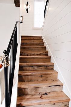 the stairs are made out of wood and have been painted white with black railings