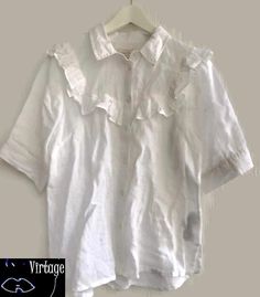 Blouse ruffled romantic white shortsleeved button up down size 42 m-L  Measurements  Bust 54cm x2 =21inches x2 Length from shoulder middle 65cm  Condition good Summer Fitted Shirt With Ruffled Collar, Fitted Shirt With Ruffled Collar For Summer, Summer Collared Ruffled Tops, Summer Collared Ruffle Tops, Summer Ruffled Collared Tops, Collared Ruffle Tops For Summer, Feminine Short Sleeve Blouse With Ruffles, Summer Collared Short Sleeve Shirt With Buttons, Summer Short Sleeve Shirt With Collar And Buttons