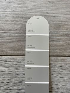 the pantone gray color swatches are shown on top of a wooden table with wood flooring