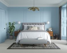 a bedroom with white walls and carpeted flooring has a large bed in the center