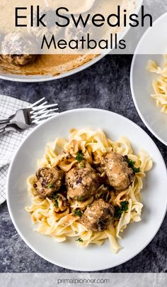 two white plates filled with meatballs and pasta on top of a gray countertop