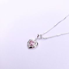 Introducing our Pink Glam Heart Necklace - crafted in Sterling Silver with a heart-shaped pink crystal at its core. This unique chain necklace features a sparkling pink crystal heart pendant, on a Sterling Silver heart shape base adding sophistication to any look. Wear it long or short with the adjustable clasp. Elevate your style with this enchanting piece that radiates love and glamour. Main Stone: heart shaped lab diamond Stone Color: pink Metal Material: 925 Sterling Silver Chain Lenght: 16 Pink Heart Pendant Clavicle Necklace, Pink Heart-shaped Jewelry With Clavicle Chain, Pink Heart-shaped Clavicle Chain Jewelry, Pink Heart Necklace With Adjustable Chain, Pink Heart Pendant Charm Necklace, Pink Heart Pendant Charm Necklace With Clavicle Chain, Pink Heart Pendant Charm Necklace On Clavicle-length Chain, Pink Pendant Crystal Necklaces For Valentine's Day, Pink Heart Charm Necklace With Adjustable Chain