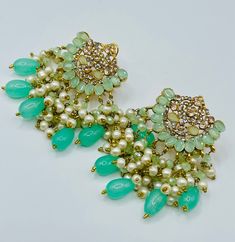 Beautiful bollywood indian pakistani gold pleated earring with pearls in mint green colour  Please keep in mind that the colour of the product shown in the pictures may vary from the original due to the lighting used. Care Instruction : Avoid Heat & Chemicals Like Perfume, Deo, Alcohol, Etc. | Clean With Dry Cotton Cloth | Pack In An Air Tight Container After Use. Elegant Pearl Earrings With Dangling Beads For Festivals, Elegant Green Chandelier Earrings With Stone Work, Elegant Kundan Chandelier Earrings With Dangling Beads, Elegant Kundan Danglers With Dangling Beads, Elegant Kundan Danglers With Beads, Gift Stone Work Pearl Drop Earrings, Gift Pearl Drop Earrings With Stone Work, Traditional Festive Beaded Pearl Drop Earrings, Traditional Festive Beaded Earrings With Pearl Drop