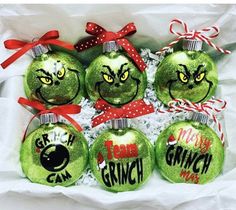 six grinch christmas ornaments in a box