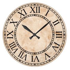 a large clock with roman numerals on the face and numbers in black ink