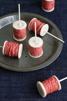 red and white spools of thread on a metal tray with toothpicks