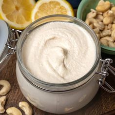 a jar filled with cashews next to other foods