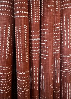 brown and white patterned curtains are lined up