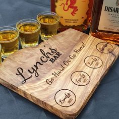 a wooden board with four glasses next to it