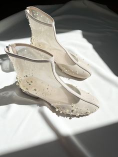 'Marry' boots are handcrafted in ivory suede with handmade embroidery, a delicate mix of pearls and beads. They have a zipper on the back for easy fitting. The heel measures 2.5 cm / 1 inch. This shoe is handmade using Italian suede, hand embroidery of pearls, and genuine leather lining. Inside there is a soft Memory foam insole, which gives a feeling of additional comfort when walking. Tunit outsole is made of a mixture of leather chips and rubber, it's more wear-resistant than leather and more durable. This type of outsoles is great for countries with rainy climates. Also, we use soft natural upper materials that wear well and take the shape of the foot. You can customize shoes' embroidery, heels, colors, etc. - we offer many options.  OUR SHOES ARE MADE-TO-MEASURE ONLY. We start to craf Elegant Spring Wedding Boots, Elegant Wedding Boots Embellished, Elegant Embellished Wedding Boots, White Closed Toe Wedding Boots, Cream Round Toe Wedding Boots, Low Heel Wedding Boots, Elegant Cream Boots With Flat Heel, Cream Embellished Round Toe Wedding Shoes, Embellished Cream Wedding Shoes With Round Toe