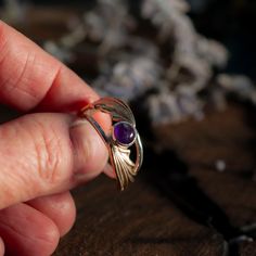 Illyrian Inspired Wings Ring is a reminder of magical tales, this classic ring has been carefully crafted for timeless beauty. Representing the beauty and grace of Illyrian wings, it’s an elegant piece sure to bring a touch of enchantment to any outfit fans of the ACOTAR series or not! Handmade in Sterling silver, brass. Sterling silver ring brass wings 6mm Amethyst inspired by Rhys's eyes 6mm Ruby inspired by Cassian's Siphons 6mm Sapphire inspired by Azriel's Siphons MADE TO ORDER. Available to ship in 5-7 business days.