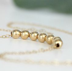 "14k Gold Filled Bead Necklace. A simple classic must-have for every woman, perfect for everyday wear. Choose from one to twenty beads or request a custom listing for more. Each dainty 6mm (1/4\") bead is strung onto a 14k gold filled cable chain that comes in several lengths... Choker style to layering... Simple elegance. If you have any questions please do not hesitate to contact me. Your order will arrive beautifully wrapped ready for gifting. Thanks so much for visiting my shop! Kay :)" Rose Gold Necklace Simple, Chef Necklace, Gold Minimalist Necklace, Silver Feather Necklace, Minimalist Necklace Gold, Spoon Necklace, Gold Chain Choker, Layered Choker Necklace, Rose Gold Beads