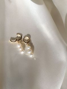 14k gold filled freshwater pearl huggie hoop earrings. hypoallergenic, tarnish-proof, and lightweight. Elegant Dangle Hoop Earrings For Mother's Day, Elegant Hoop Earrings For Mother's Day, Elegant Hoop Earrings For Anniversary And Mother's Day, 14k Gold Filled White Bridal Earrings As Gift, White 14k Gold Filled Bridal Earrings As Gift, Elegant Hoop Earrings For Wedding And Mother's Day, Minimalist Earrings For Everyday And Mother's Day, Minimalist Dangle Jewelry For Mother's Day, Minimalist Hypoallergenic Earrings For Mother's Day