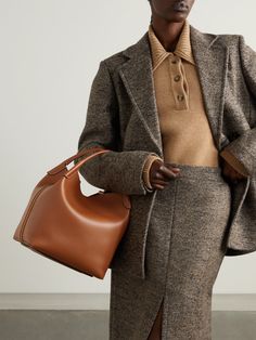 Loro Piana's bag is an accessory to wear now and love forever. Handmade from soft leather, it has a sleek shape inspired by cashmere storage bales. Stow your water bottle, wallet and small cosmetics case in the spacious interior. Designer Structured Shoulder Bag For Everyday, Designer Structured Everyday Bag, Luxury Bucket Bag With Removable Pouch For Fall, Luxury Fall Bucket Bag With Removable Pouch, Formal Fall Bags With Leather Handles, Designer Hobo Bag With Top Handle For Business, Designer Structured Brown Bags, Designer Structured Bags For Work, Designer Structured Workwear Bags