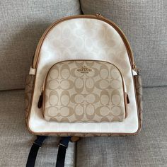 Color: Gold/Chalk/Glacier White Multi Refined Pebble Leather Inside Zip And Multifunction Pockets Double Zip Closure, Fabric Lining Handle With 2 1/4" Drop Outside Zip Pocket Adjustable Shoulder Straps 10 3/4" (L) X 12 1/2" (H) X 4 3/4" (W) White Standard Backpack For On-the-go, Designer White Travel Backpack, Designer White Backpack For Travel, White Backpack With Removable Pouch For On-the-go, White Luxury Backpack With Removable Pouch, White Coach Backpack For Travel, Luxury White Backpack With Removable Pouch, Luxury White Standard Backpack, Modern White Rectangular Backpack