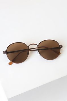 Sunny days don't stand a chance with the Lulus Agreed Bronze Round Sunglasses! These trendy bronze round sunnies feature a sleek wire-frame with brown tinted lenses. Engraved detail along nose bridge and arms. Get ready for these shades to be your favorite go-to pair! Frames measure 5. 5" wide. Arms measure 5. 5" long. Nickel, brass and plastic. Imported. Lulus | Agreed Bronze Round Sunglasses. Brown Round Sunglasses For Beach, Casual Brown Sunglasses With Metal Frame, Brown Round Sunglasses For Summer, Classic Brown Sunglasses For Spring, Brown Tinted Sunglasses For Spring, Brown Aviator Sunglasses With Uv Protection For Spring, Brown Aviator Sunglasses With Uv Protection, Brown Round Frame Sunglasses With Metal Frame, Brown Round Frame Metal Sunglasses