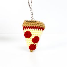 a crocheted keychain with a piece of pizza on it's side