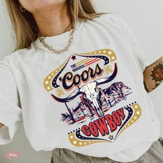 Saddle up and embrace the vintage western vibes with our Comfort Colors Original Coors Rodeo T-Shirt. With its vintage-inspired design and authentic western graphics, it's the perfect choice for cowgirls and rodeo enthusiasts alike. The Comfort Colors fabric provides a soft and comfortable feel, ensuring that you'll stay stylish and at ease all day long. Whether you're headed to a rodeo event, hanging out at the ranch, or simply looking to add a touch of western flair to your outfit, this shirt is a standout choice. Its timeless appeal and original cowgirl charm make it a must-have for anyone who loves the rodeo lifestyle. So grab your hat, dust off your boots, and show off your love for all things western with this one-of-a-kind Rodeo T-Shirt. Check out our other western listings: https:/ White Western T-shirt For Rodeo, White Crew Neck Tops For Western-themed Events, Western White Crew Neck Tops, White Western Crew Neck Top, White Western Style Crew Neck Top, White Crew Neck Western Top, White Letter Print Top For Rodeo, Retro T-shirt For Western-themed Summer Events, Retro Summer T-shirt For Western-themed Events