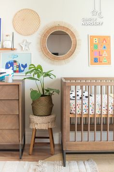 a baby crib with a potted plant in it next to a wooden dresser