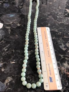 "Vintage Green Jade Beaded Necklace, 24\" Jade and 14K Gold. This beautiful jade necklace has 73 round light green jade beads along with a 14K gold clasp marked 14K 585 and 8 gold beads. We are fairly certain this was purchased in Hong Kong back in the 1980's as a gift for grandmother. It shows no real signs of wear. It comes with a craft gift box." Elegant Jade Jewelry With Large Beads, Elegant Jade Beads For Jewelry Making, Jade Beaded Necklace With Gemstone Beads, Beaded Jade Necklaces With Gemstone Beads, Jade Beaded Necklaces With Gemstone Beads, Large Jade Bead Jewelry, Elegant Jade Gemstone Beads, Jade Necklaces With Faceted Round Beads, Round Jade Necklace With Faceted Beads