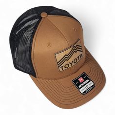 a brown and black trucker hat with the word toyota on it's front