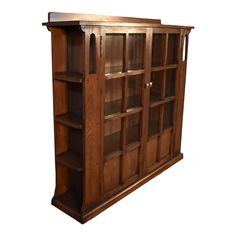 a wooden bookcase with glass doors and shelves