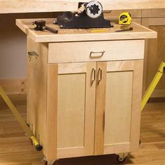 a workbench with tools on it in the middle of a wooden floored room