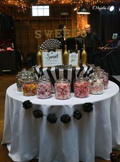 a table topped with lots of candy jars