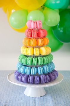 a stack of colorful macaroons sitting on top of a plate