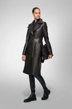 Women's Leather Coat In Black Embrace timeless elegance with our women's leather coat in black. Crafted from genuine sheepskin leather with a semi-aniline finish, it exudes luxury and durability. The coat features a stylish turn-down collar, a zipper closure, and open hem cuffs for a classic look. Practicality meets sophistication with one inside pocket and two side pockets. This black leather coat offers the perfect blend of style and functionality, making it an essential addition to any wardrobe. Outer Shell: Genuine Leather Leather Type: Sheepskin Leather Finish: Semi-aniline Closure Style: Zipper Collar Style: Turn Down Cuffs Style: Open Hem Inside Pockets: One Outside Pockets: Two Side Pocket Color: Black Sleek Long Leather Coat, Elegant Black Leather Jacket With Leather Lining, Elegant Winter Leather Jacket With Leather Lining, Modern Long Leather Coat, Luxury Leather Jacket For Fall, Sleek Winter Leather Jacket For Office, Luxury Long Leather Workwear Jacket, Modern Leather Outerwear For Evening, Sleek Leather Jacket For Evening