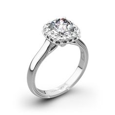 a white gold engagement ring with an oval diamond center