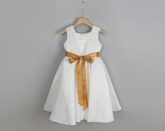 Make your little one feel like a princess with our elegant Ivory Satin Flower Girl Dress, available with a choice of gold, rose gold, or ivory sash. This stunning dress features a soft ivory satin bodice paired with a flowy tulle skirt, perfect for weddings or any special occasion. The variety of sash colors adds a touch of customization and sophistication, making it an ideal choice for both big sister and little sister to shine at the event. Whether for a wedding party or a formal celebration, Gold Sash, Satin Flower Girl Dress, Girls Tulle Dress, Big Sister Little Sister, Sisters Dress, Smash Cake Photoshoot, Satin Flowers, Stunning Outfits, Dress Satin