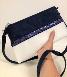 "Navy blue and white shoulder bag with matching sequins, in suedette with a very velvety feel, suede effect. The zippered pocket is decorated with navy blue sequins on both sides. Of beautiful dimensions, this shoulder bag will easily contain your essentials, keys, papers, phone, ... etc. Height: 18 cm, length at the base 31 cm, length of the zip 25 cm, thickness 6 cm. By its design, it has a very nice hold, even empty!  It is fully lined inside with a coordinated printed cotton fabric. (Warning: the fabrics I use for the inside lining may vary but are always perfectly matched with the style and colors of the article) A large coordinated suedette tassel adorns the zipper slider. A removable shoulder strap (2 silvered and riveted snap hooks) in suedette will allow you to carry it on your sh White Shoulder Bag With Zipper Closure For Evening, White Evening Bag With Zipper Closure, White Party Bags With Zipper Closure, White Party Clutch Crossbody, Navy Blue Decor, White Shoulder Bag, Printed Cotton Fabric, Suede Tassel, Vanessa Bruno