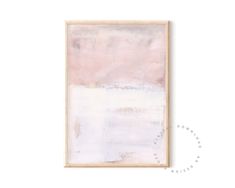 a painting hanging on the wall next to a white frame with a pink and grey background