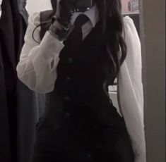 a woman taking a selfie in front of a mirror